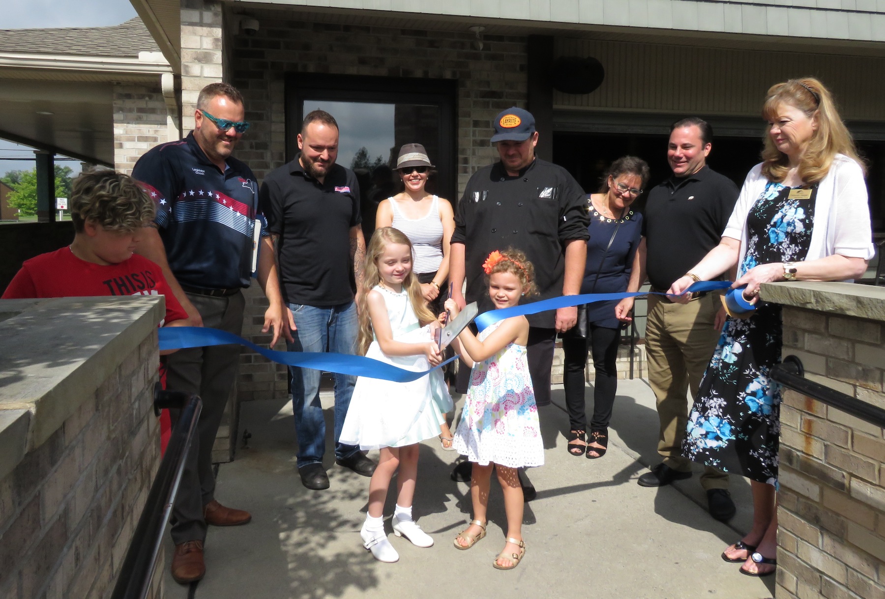 Friends, partners and family of Denny Soliday, along with Niagara County Legislator Jesse Gooch cut the ribbon to Solidays Bar & Grille's next setting at 6935 Ward Road. (Photos by David Yarger)
